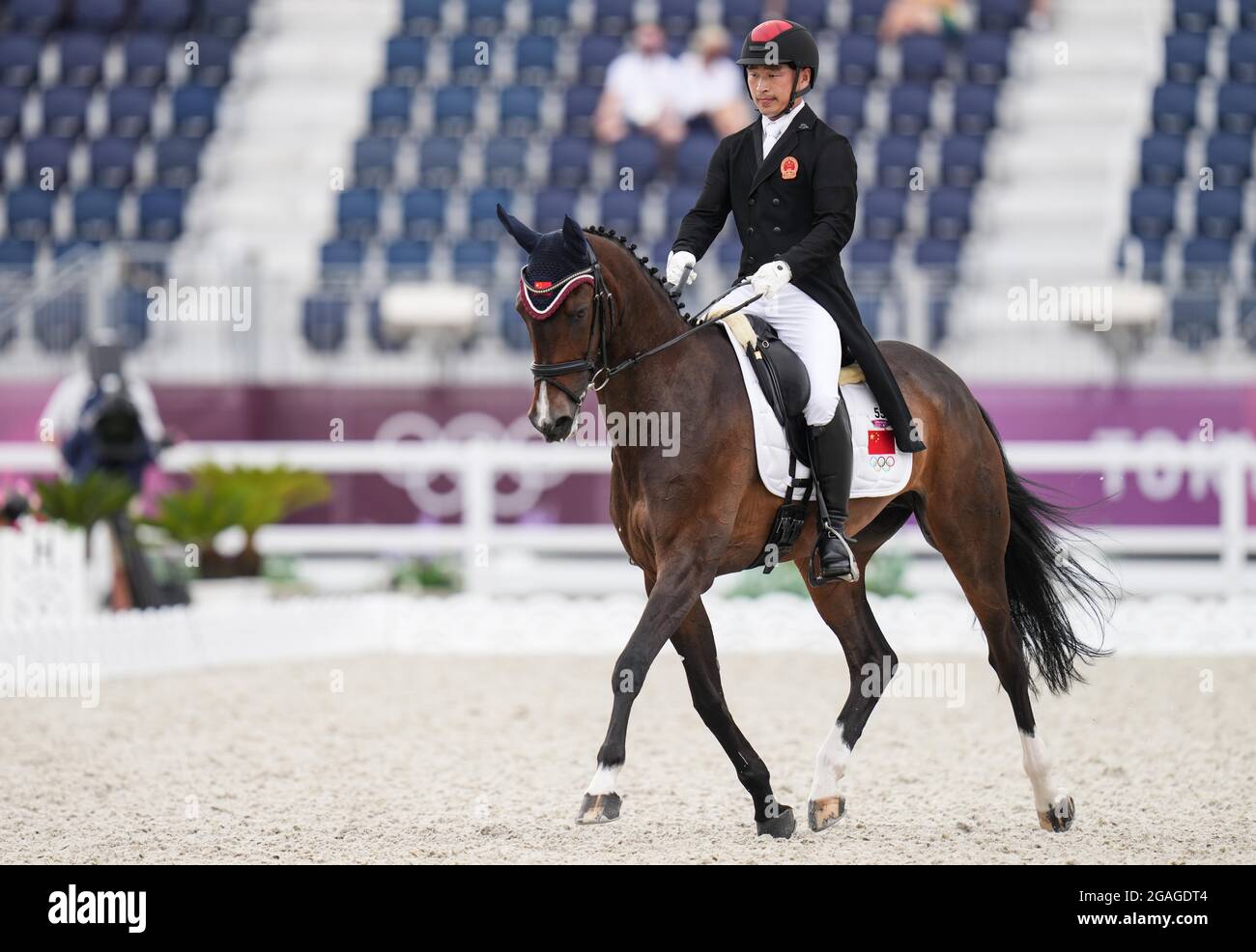 Tokyo, Japan. 31st July, 2021. Bao Yingfeng of China and his horse Flandia 2 perform during the equestrian dressage event at the Tokyo 2020 Olympic Games in Tokyo, Japan, July 31, 2021. Credit: Zhu Zheng/Xinhua/Alamy Live News Stock Photo