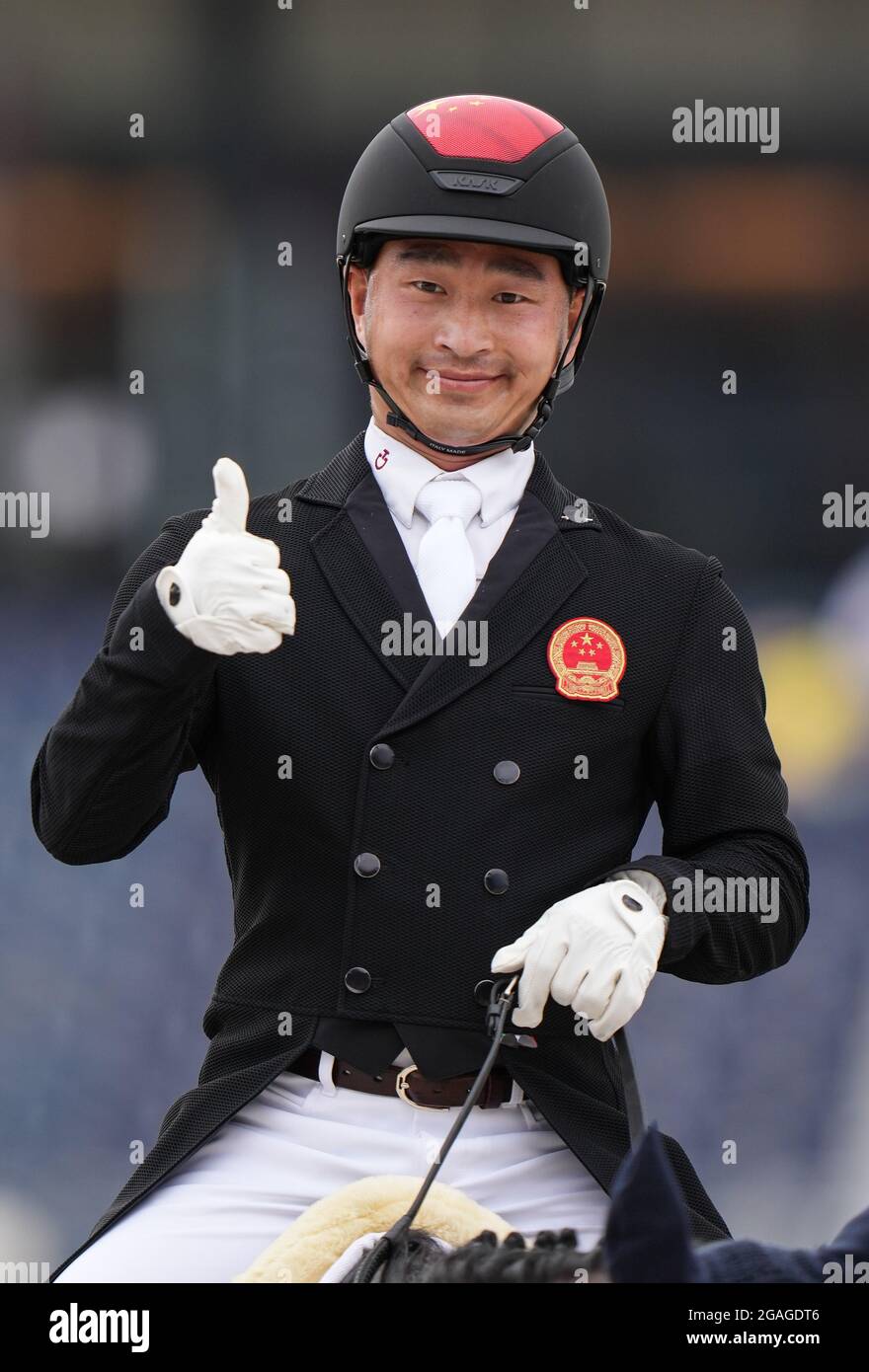 Tokyo, Japan. 31st July, 2021. Bao Yingfeng of China gestures during the equestrian dressage event at the Tokyo 2020 Olympic Games in Tokyo, Japan, July 31, 2021. Credit: Zhu Zheng/Xinhua/Alamy Live News Stock Photo
