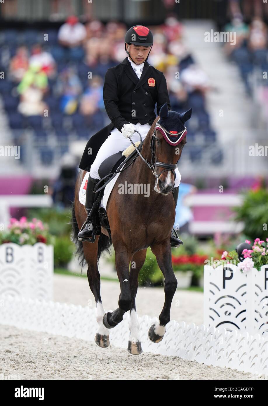 Tokyo, Japan. 31st July, 2021. Bao Yingfeng of China and his horse Flandia 2 perform during the equestrian dressage event at the Tokyo 2020 Olympic Games in Tokyo, Japan, July 31, 2021. Credit: Zhu Zheng/Xinhua/Alamy Live News Stock Photo