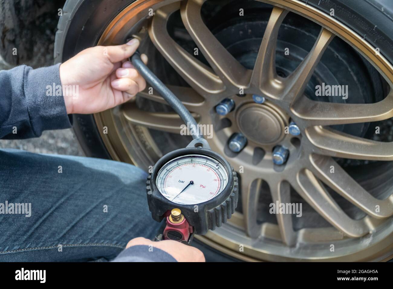 Tire Pressure Gauge and technician hands checking tyre pressure Stock Photo Alamy