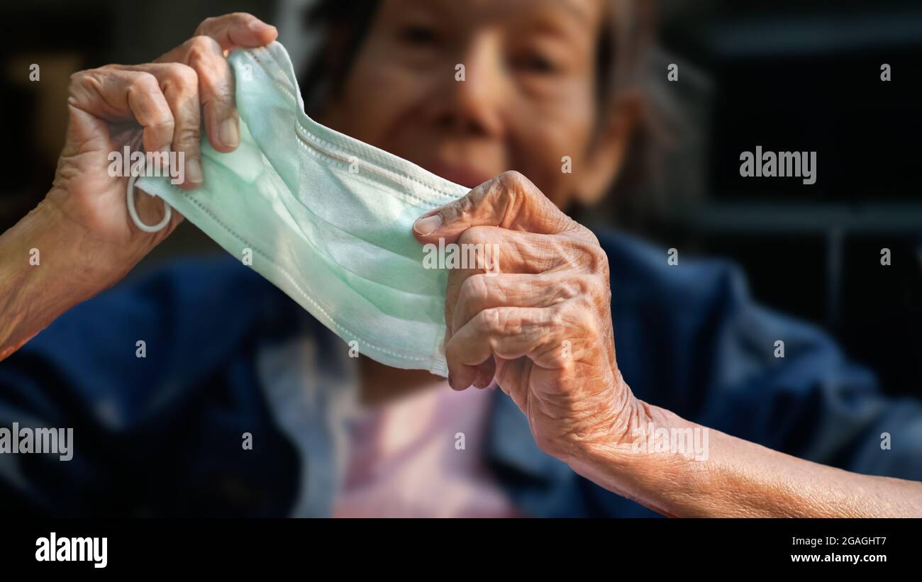 Elderly woman wearing a mask hi-res stock photography and images - Alamy