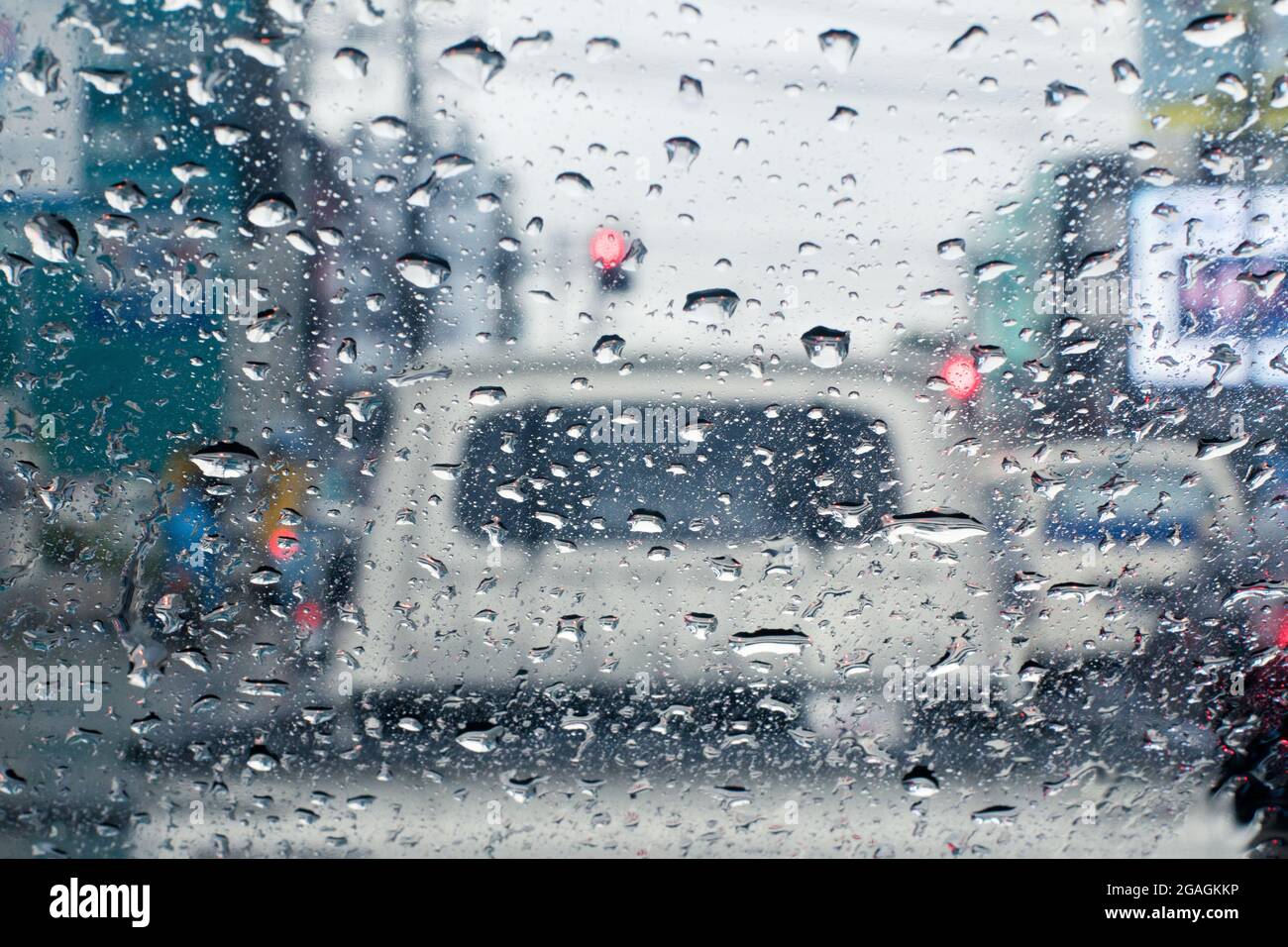 Raindrops on windshield from inside the car in traffic jam Stock Photo
