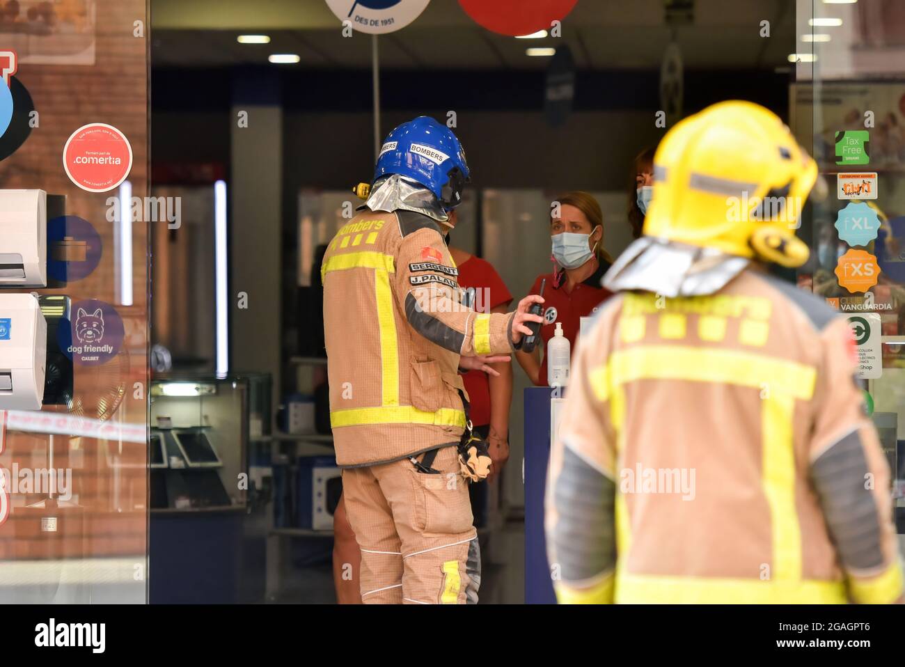Sergeant J Palau of the Catalonia Firefighters speaks to the employees of an electrical appliance store to leave the area due to a possible gas leak in Vendrell. A strong smell of gas alerted the residents of San Jordi Street, Vendrell where three teams of Catalonia Firefighters and several Local Police patrols attended closing access to the affected area. Firefighters with the help of technicians of the gas company began the gas measurements since the smell was coming from the underground sewer network and the presence of vapors or levels of propane, butane or natural gas was ruled out, hence Stock Photo