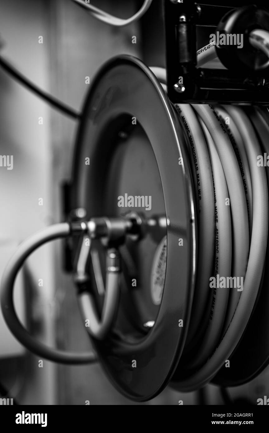 Wall mounted hose reel Black and White Stock Photos & Images - Alamy