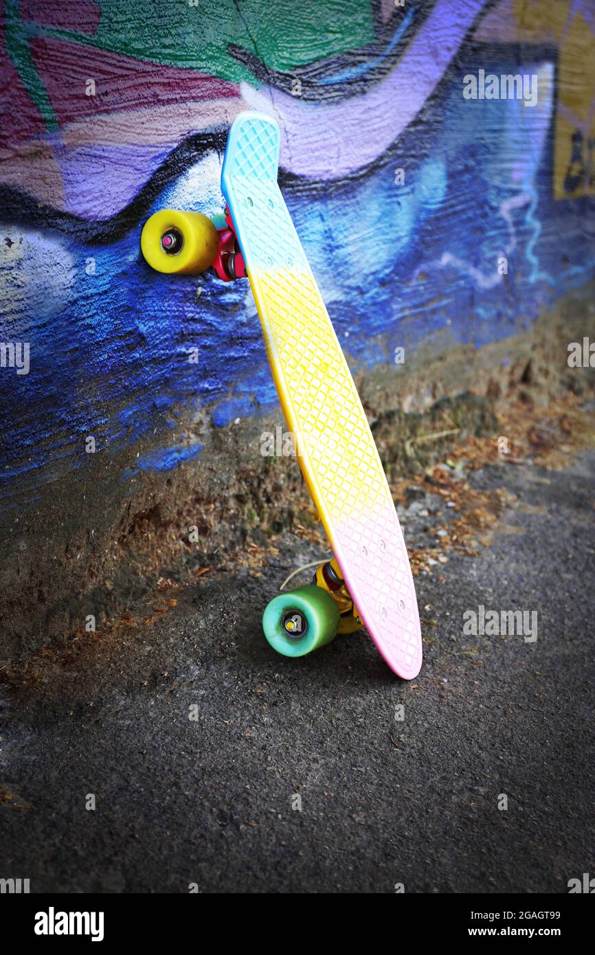 Skating board near the painted wall background Stock Photo Alamy