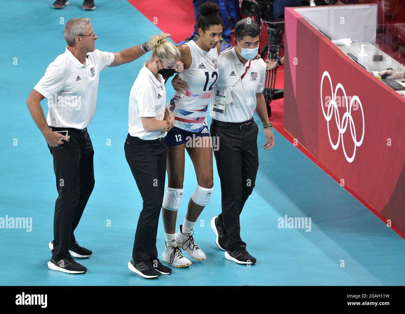 Tokyo, Japan. 31st July, 2021. Members of the United States team assist Jordan Thompson (12) off the court after she injured her ankle during play with the Russian Olympic Committee (ROC) during Women's Volleyball match at the Tokyo 2020 Olympics, Saturday, July 31, 2021, in Tokyo, Japan. ROC beat USA in straight sets, 25-20, 25-12 and 25-19. Photo by Mike Theiler/UPI Credit: UPI/Alamy Live News Stock Photo