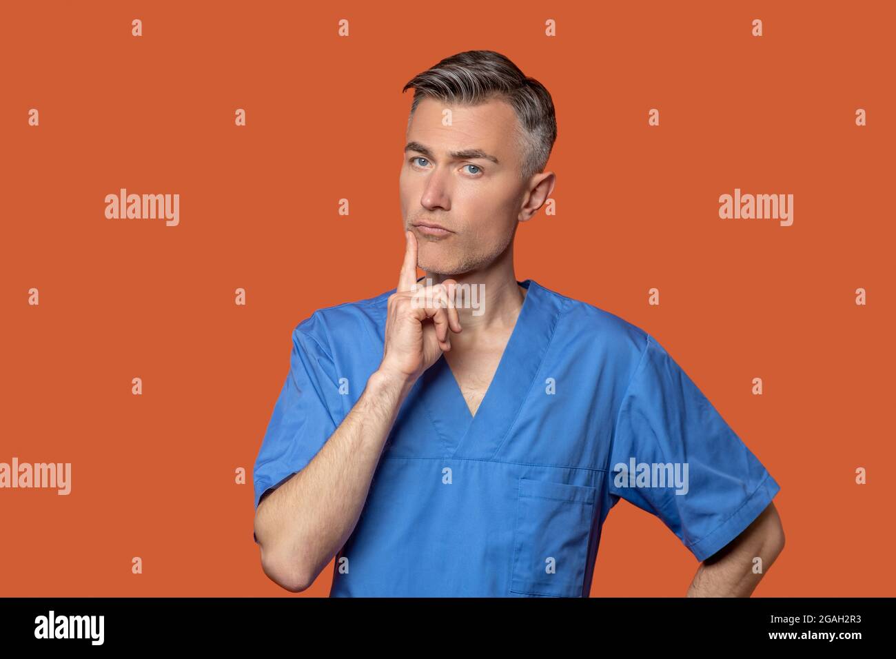 Pensive smart man in medical clothes Stock Photo