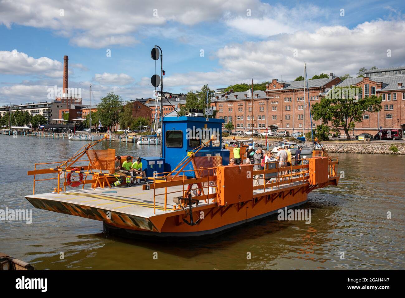 Little orange ferry called Föri crossing River Aura in Turku, Finland Stock Photo