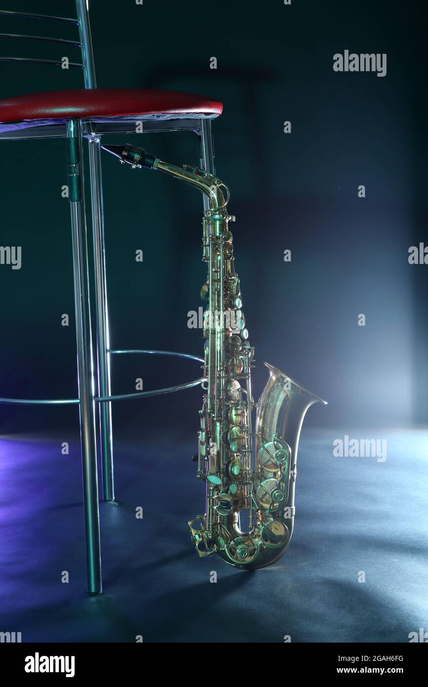 Beautiful golden saxophone near bar stool on a scene Stock Photo Alamy