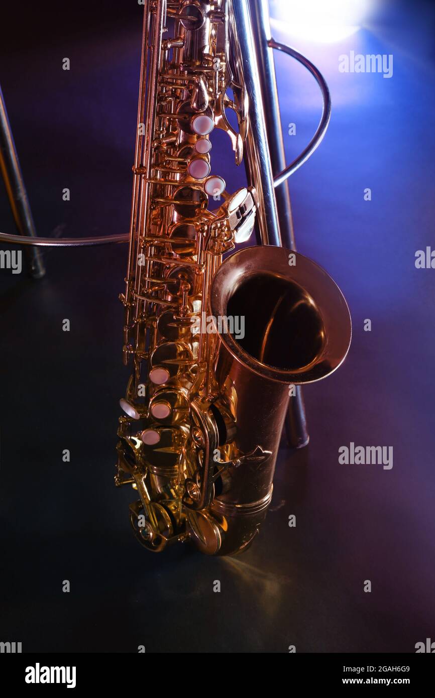 Beautiful golden saxophone near bar stool on a scene Stock Photo Alamy