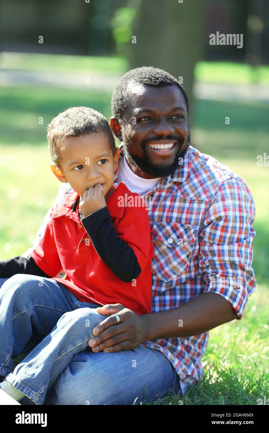 Father and son playing on grass in the park Stock Photo - Alamy