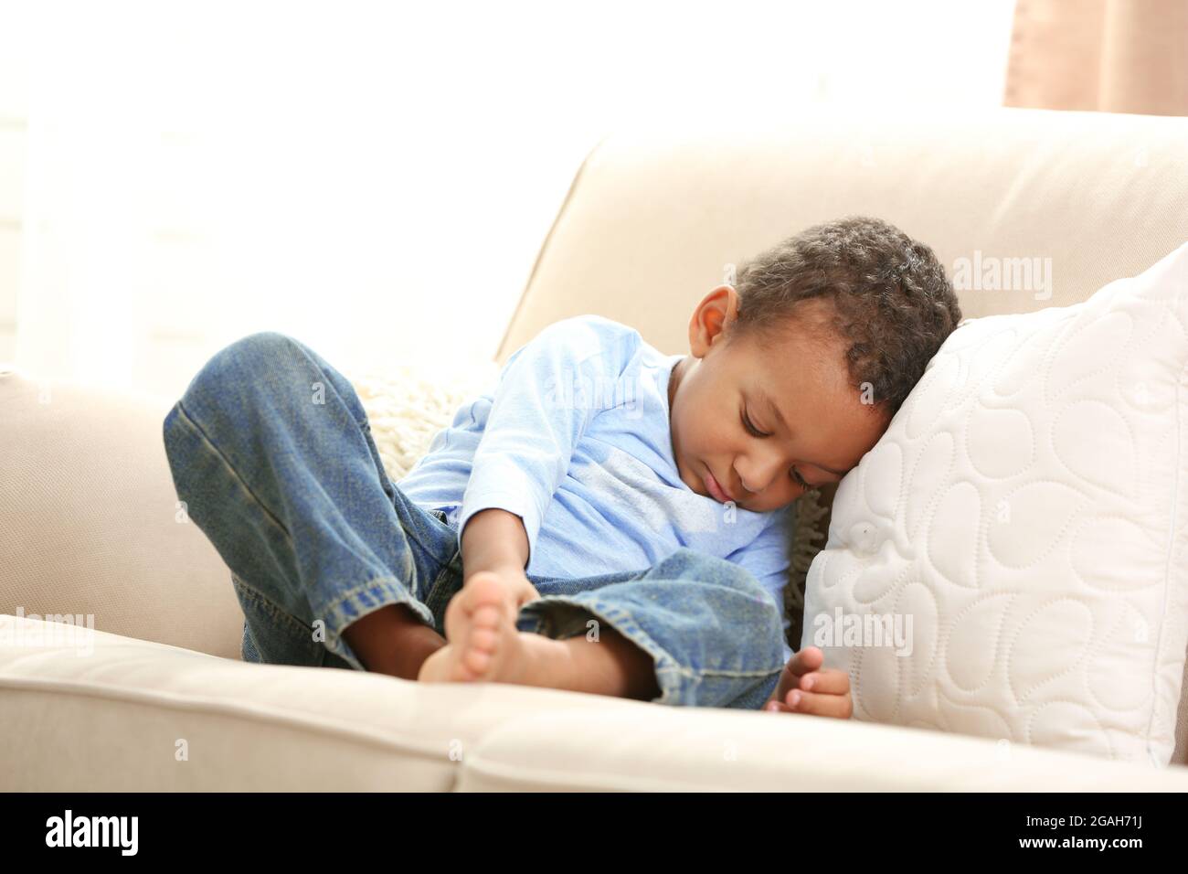 Little boy sleeping on sofa in the room Stock Photo Alamy