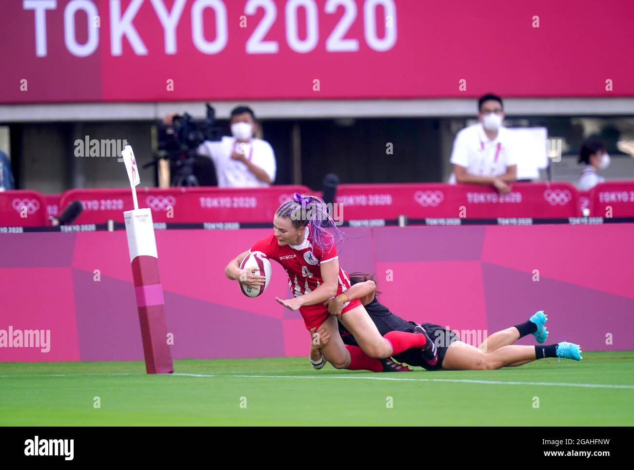 Russian Olympic Committee's Alena Tiron (left) scores their side's first try of the game during the Rugby Sevens Women's Placing 7-8 match at the Tokyo Stadium on the eighth day of the Tokyo 2020 Olympic Games in Japan. Picture date: Saturday July 31, 2021. Stock Photo