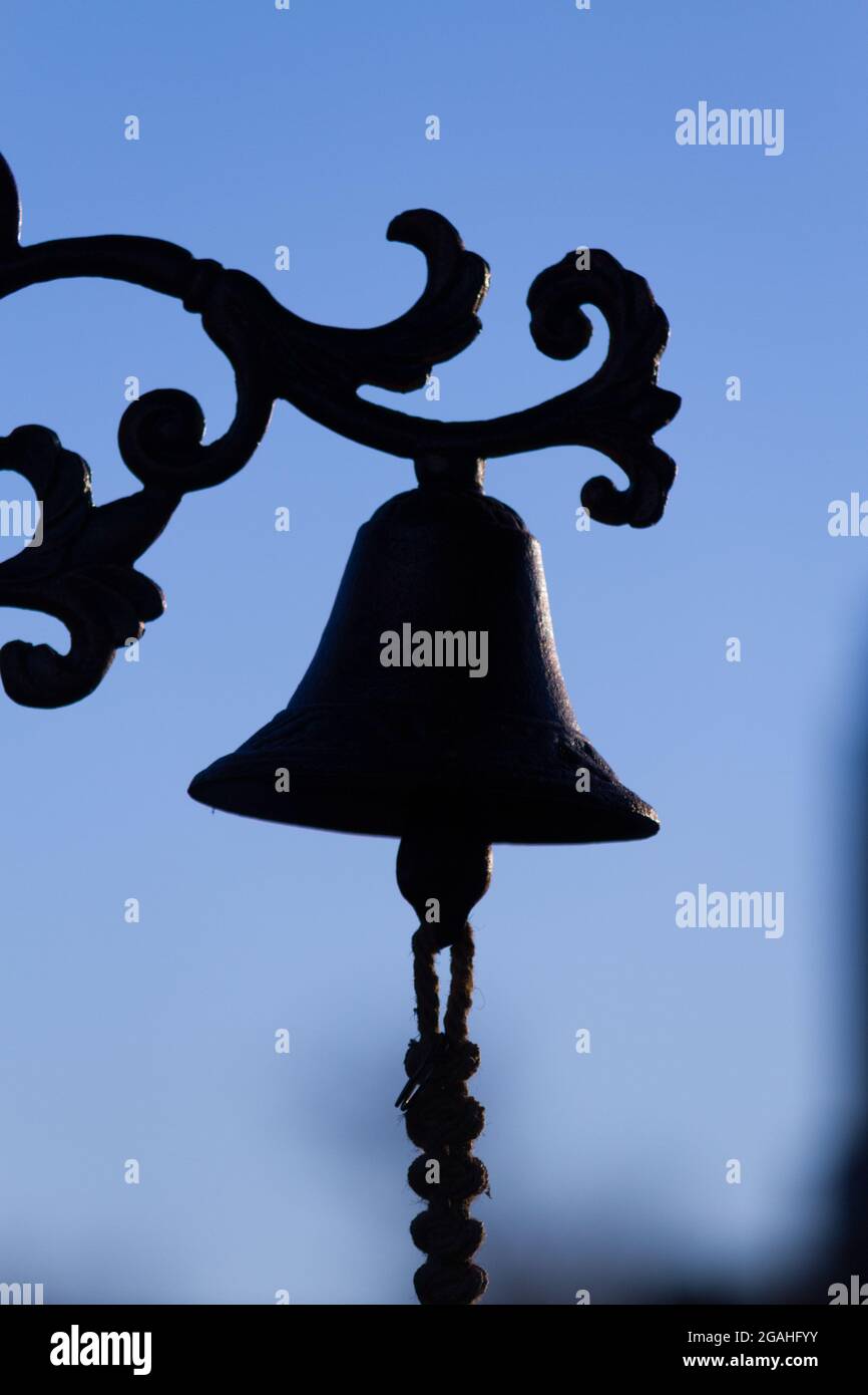 Old church bells silhouette against the blue sky Stock Photo