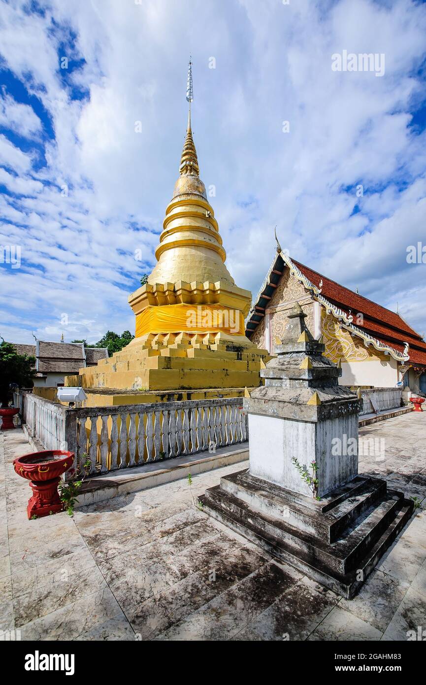 golden pagodas and temple building with blue cloudy sky in background ...