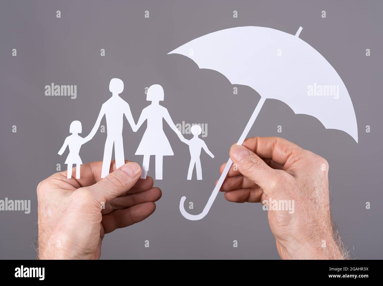 Hand holding umbrella family hi-res stock photography and images - Alamy