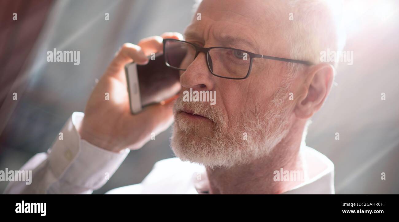 Man Using Cell Phone Light Face Portrait of senior businessman talking on mobile phone, light effect ...