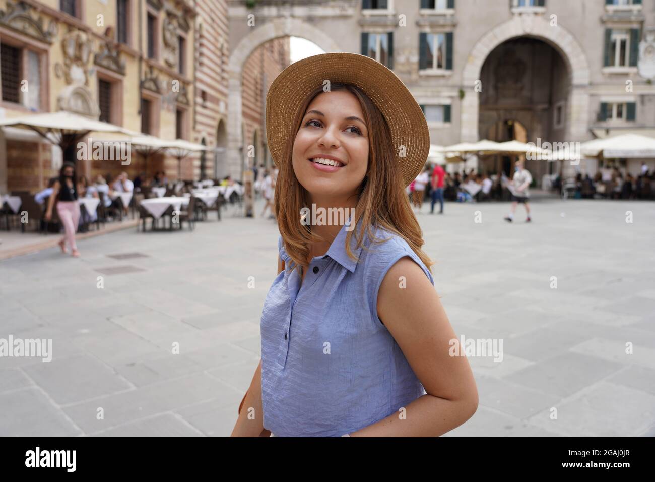 Fashionable young woman visiting the city of Verona in Italy in her cultural tour in Europe. Stock Photo