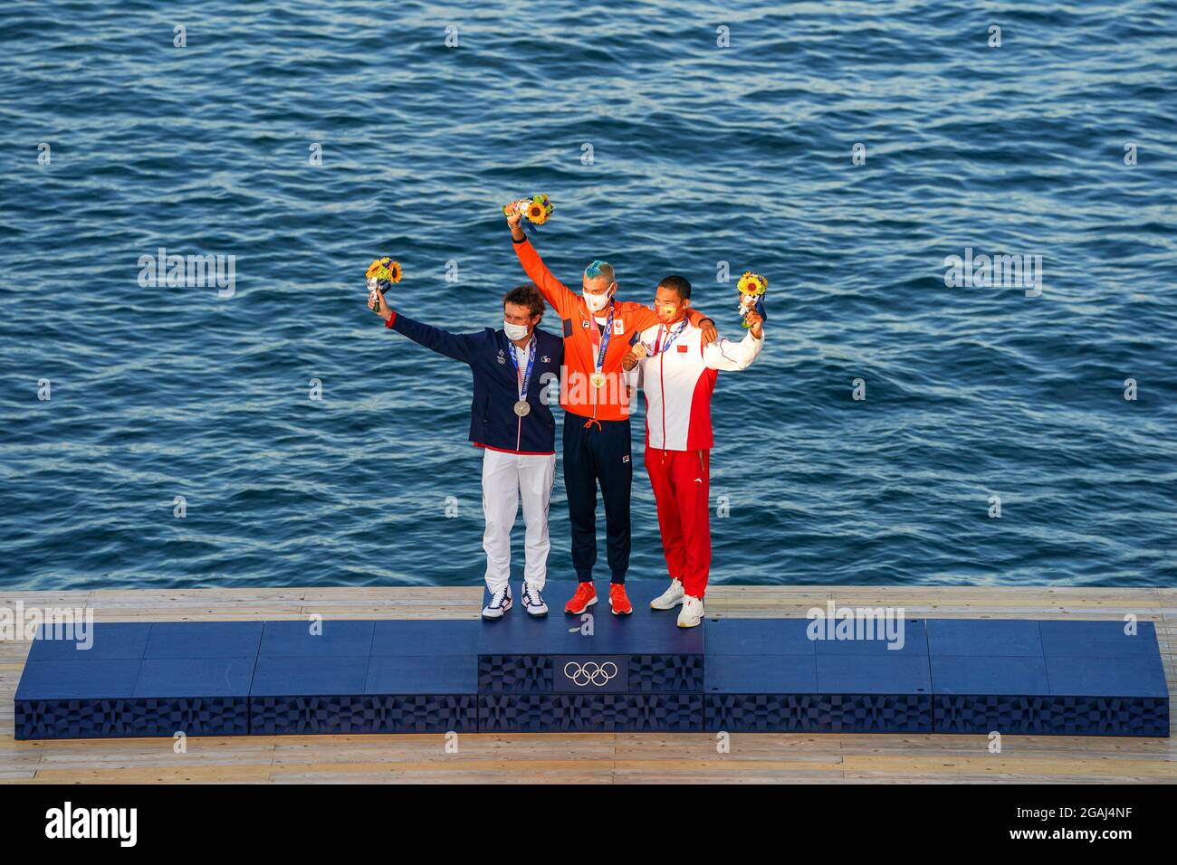 Tokyo, Japan. 31st July, 2021. TOKYO, JAPAN - JULY 31: Thomas Goyard of France winner of silver, Kiran Badloe of the Netherlands winner of gold and Kun Bi of China winner of bronze poses for a photo during the Medal Ceremony of Sailing during the Tokyo 2020 Olympic Games at the Enoshima on July 31, 2021 in Tokyo, Japan (Photo by Ronald Hoogendoorn/Orange Pictures) Credit: Orange Pics BV/Alamy Live News Stock Photo