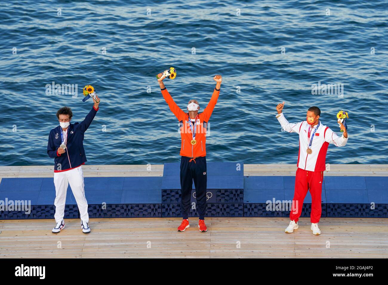 Tokyo, Japan. 31st July, 2021. TOKYO, JAPAN - JULY 31: Thomas Goyard of France winner of silver, Kiran Badloe of the Netherlands winner of gold and Kun Bi of China winner of bronze poses for a photo during the Medal Ceremony of Sailing during the Tokyo 2020 Olympic Games at the Enoshima on July 31, 2021 in Tokyo, Japan (Photo by Ronald Hoogendoorn/Orange Pictures) Credit: Orange Pics BV/Alamy Live News Stock Photo
