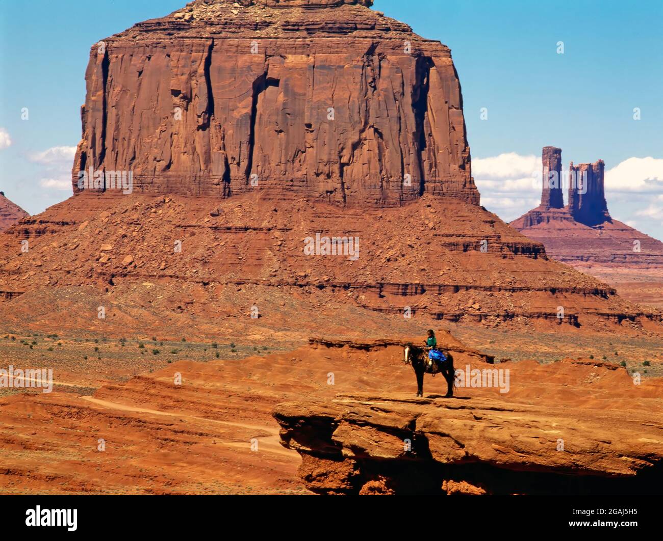 Navajo girl on horse back in Monument Valley Stock Photo