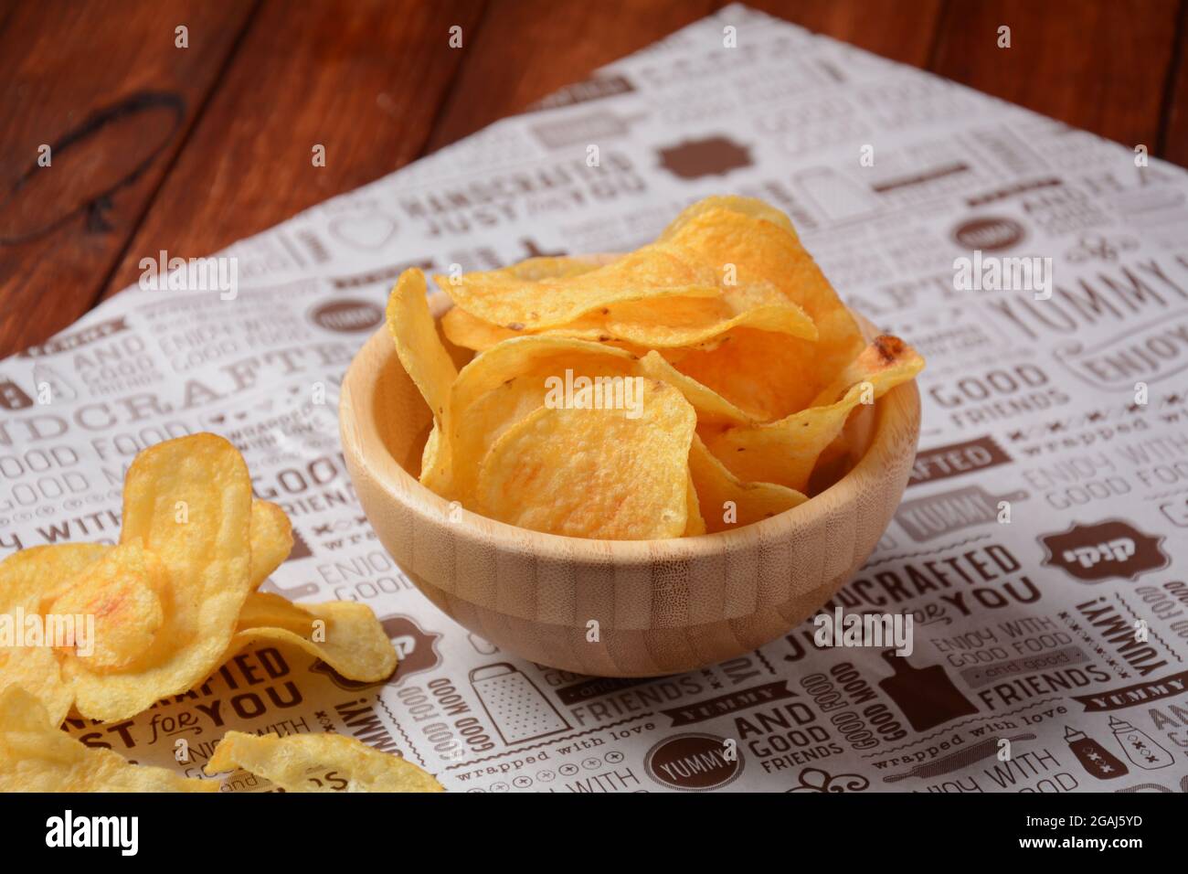 Potato chips in wooden bowls and on craft paper. Snacks to beer Stock