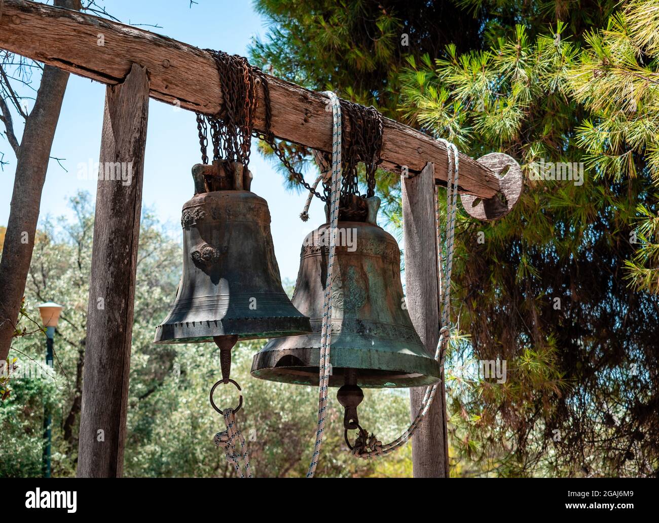 Two old bells hanging in front of the small chapel of Agios Dimitrios Loubardiaris, which is found at the foot of the Hill of the Nymphs, in Athens. Stock Photo