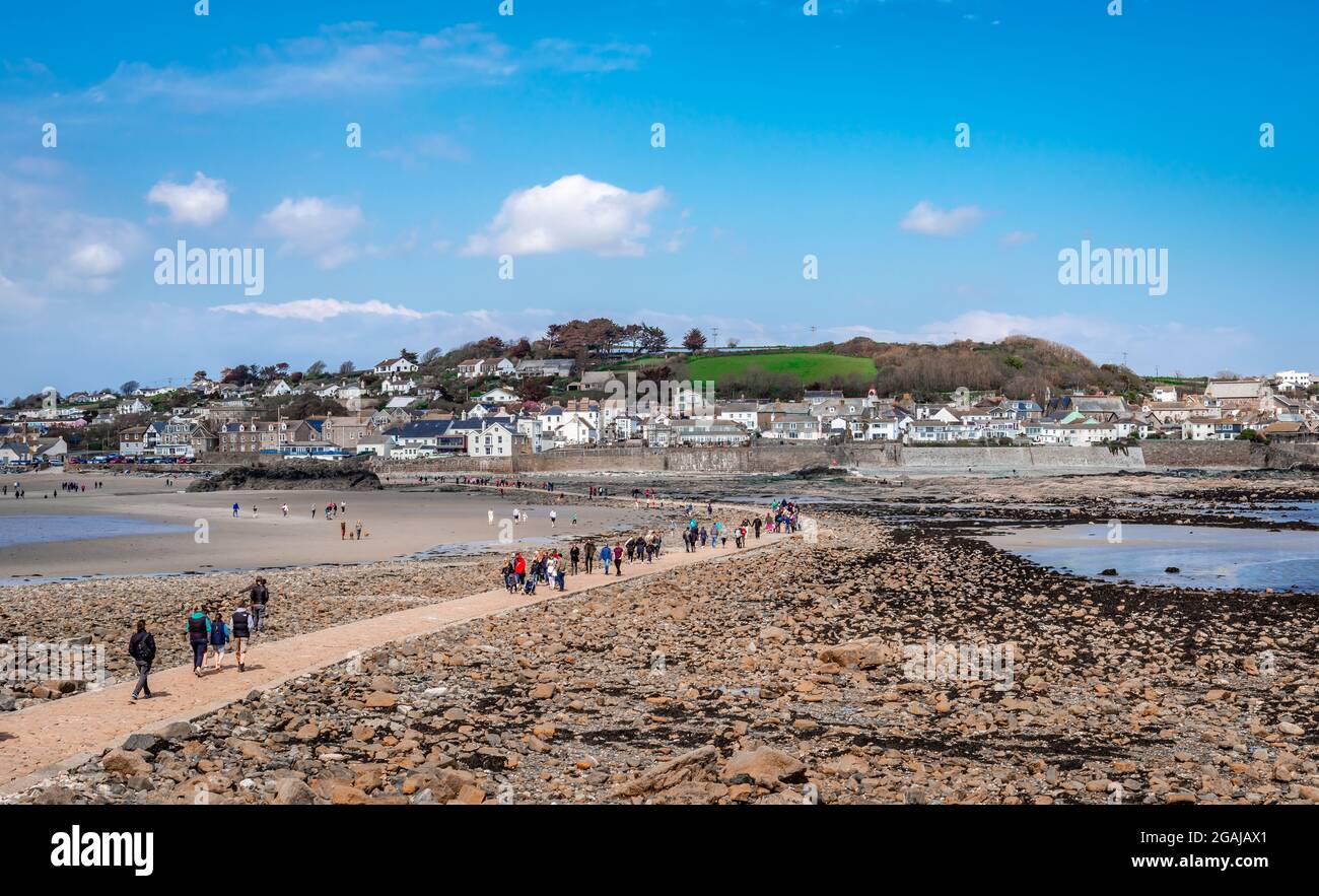 View of the causeway that links the tidal island to Marazion, the town in the shore of Mount's Bay seen in the background. Low tide. Stock Photo