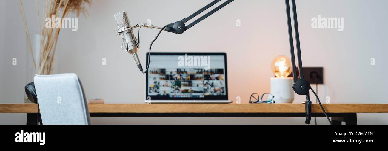 Wide image. Studio podcast interior. Homemade room for podcaster. Voice microphone laptop and lamp on the wooden table Stock Photo Alamy