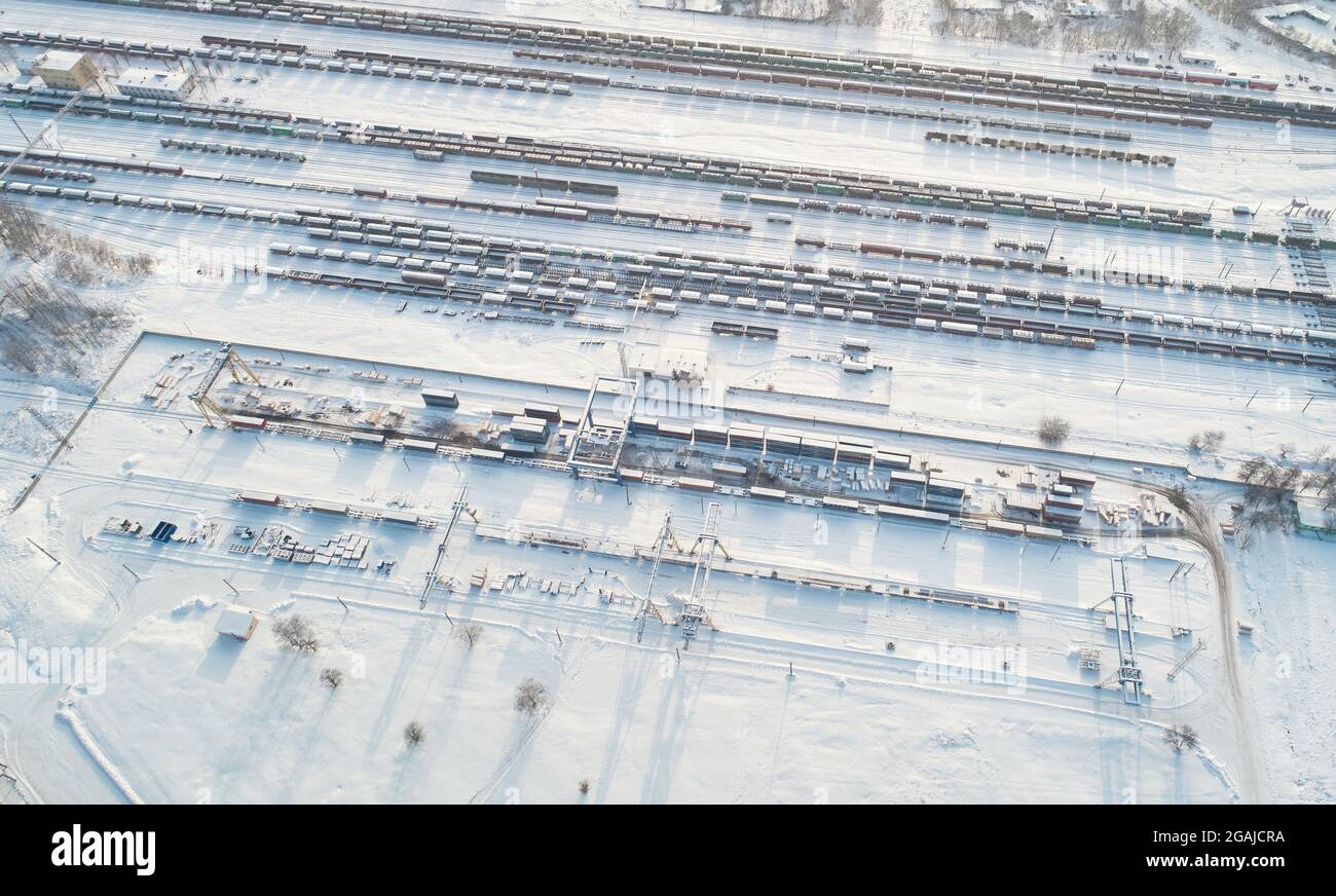 Railroad cargo terminal hub in winter snow time aerial above top drone view Stock Photo