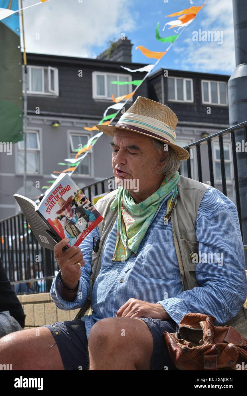 Bantry, West Cork, Ireland. 30th July 2021. Ian Bailey’s appeal against his conviction for drug driving and the possession of drugs has been adjourned until October. Pictured below Ian Bailey at Bantry market selling books and signing them. Credit: Karlis Dzjamko/Alamy Live News Stock Photo