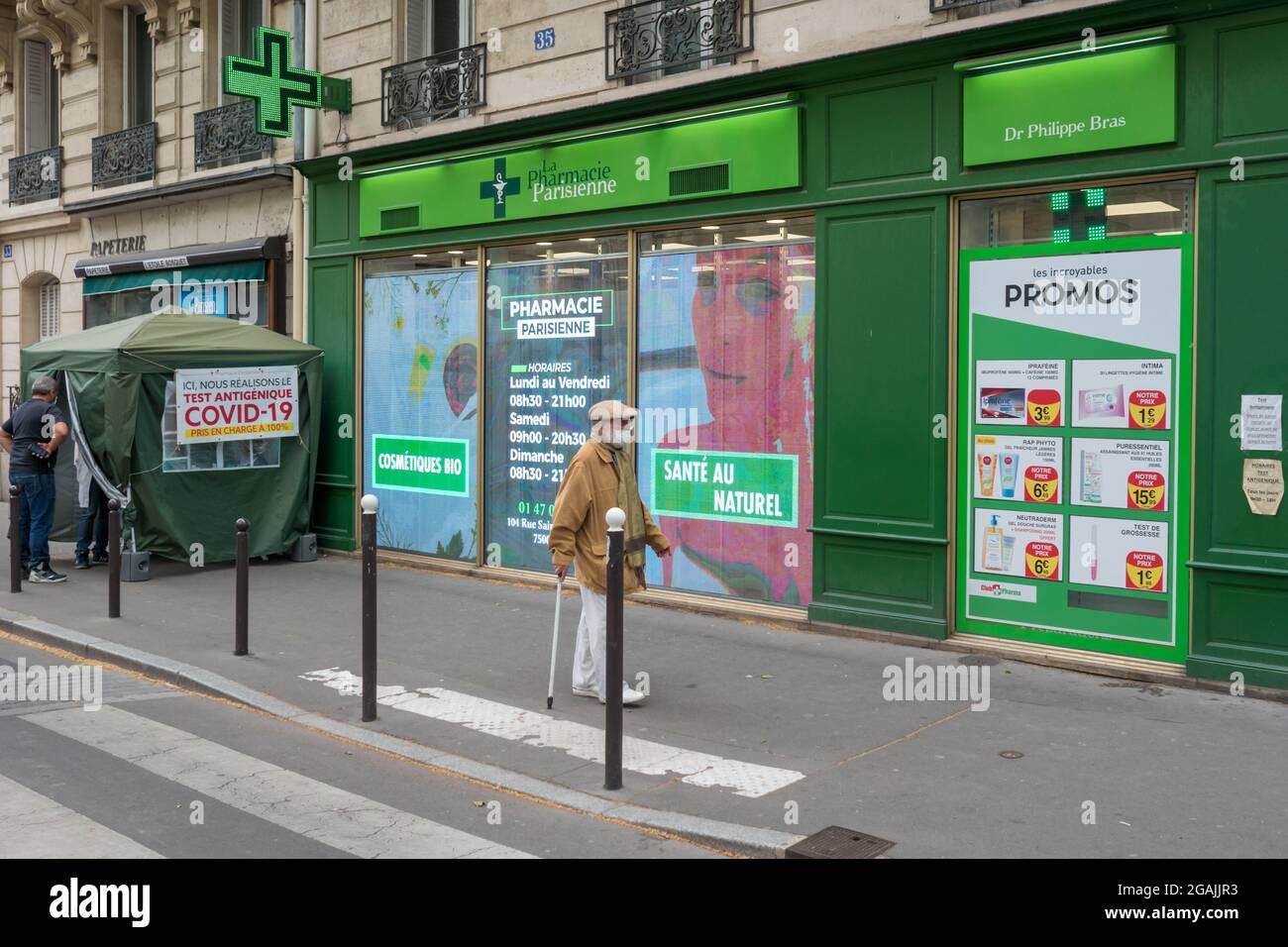 PAR, FRANCE - Jul 08, 2021: A Pharmacy building facade with Covid19 testing center tent in Paris, France Stock Photo