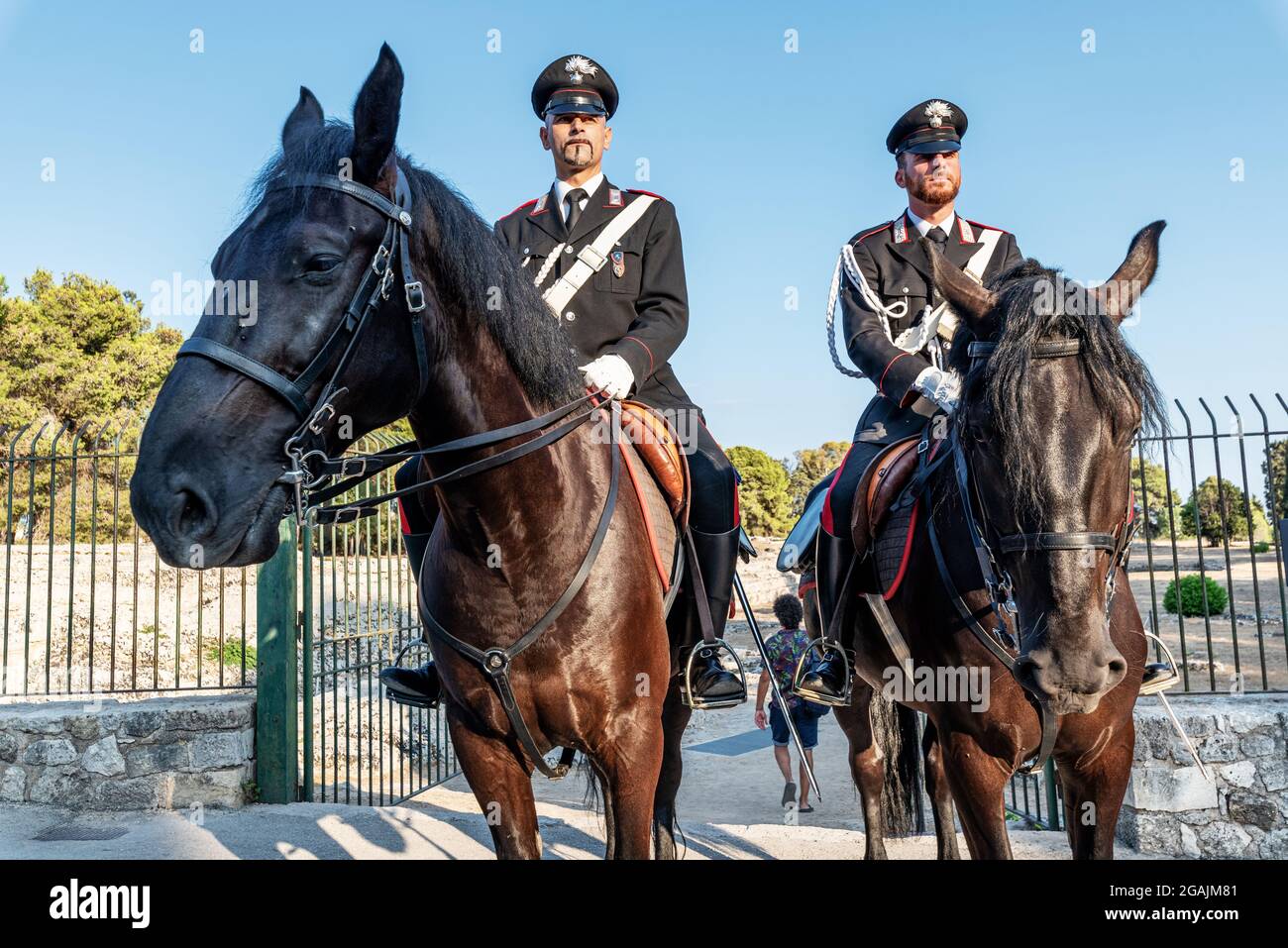 Syracuse Sicily Italy - july 22 2021: Two proud carabinieri on horseback inside the archaeological park of Neapolis Stock Photo