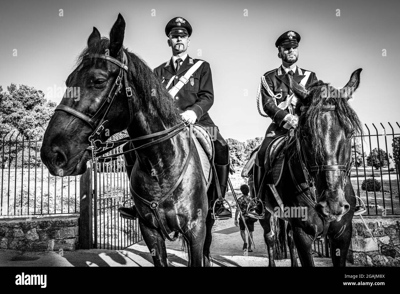 Syracuse Sicily Italy - july 22 2021: Two proud carabinieri on horseback inside the archaeological park of Neapolis Stock Photo