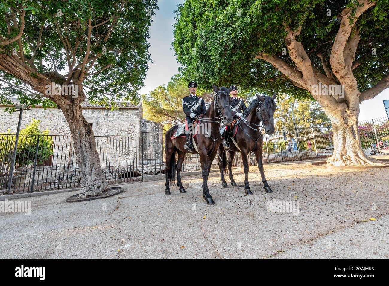 Syracuse Sicily Italy - july 22 2021: Two proud carabinieri on horseback inside the archaeological park of Neapolis Stock Photo