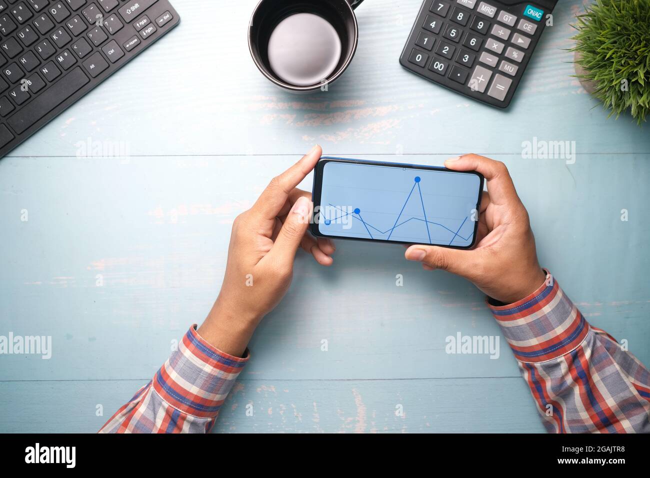 young man analyzing stock chart on smart phone  Stock Photo