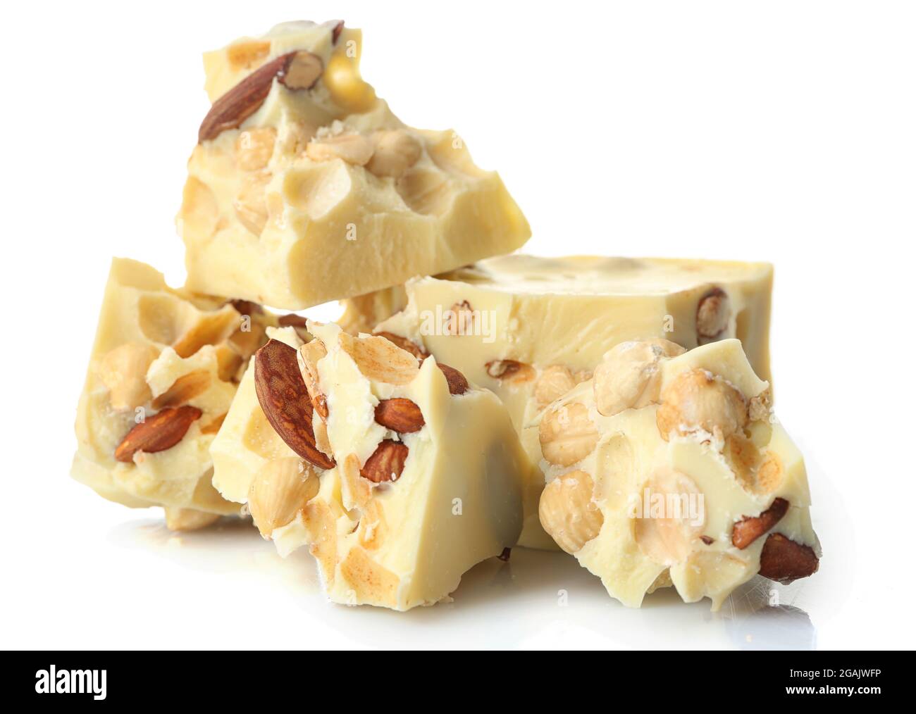 White chocolate pieces with nuts isolated on white Stock Photo - Alamy