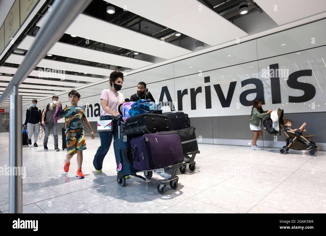 London, UK. 31st July, 2021. Passengers arriving at Terminal 5. Adults who have been fully vaccinated through the NHS now don't need to self-isolate when they return from most amber list countries. Children also don't have to quarantine. Credit: Mark Thomas/Alamy Live News Stock Photo