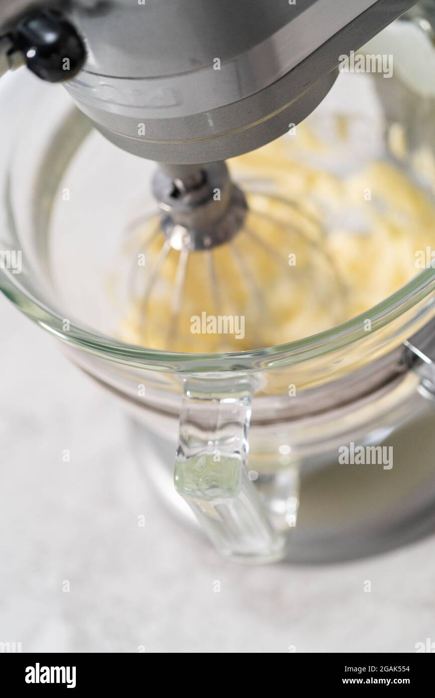 https://c8.alamy.com/comp/2GAK554/whipping-strawberry-buttercream-frosting-in-a-stand-alone-electric-mixer-with-a-whisk-attachment-2GAK554.jpg