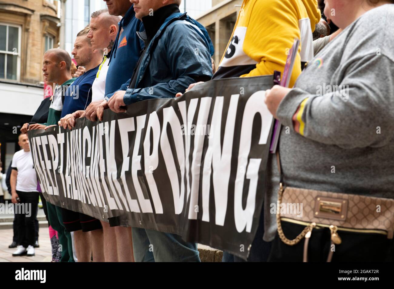 Glasgow, Scotland, UK. 30 July 2021.  PICTURED:  People speaking about their experiences of steps of Buchanan Street. Drug deaths in Scotland have increased to a new record peak for the seventh year in a row, according to “horrifying and heartbreaking” figures published today.  The “shocking” news that 1,339 people died from drugs in 2020 means that Scotland’s drug death rate remains by far the worst in Europe.  Credit: Colin Fisher Stock Photo