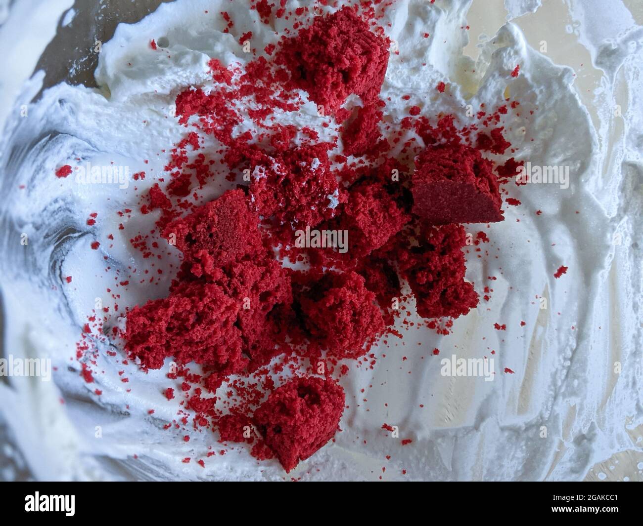 Red velvet cake and creamy frosty. Red velvet crumbs with frosting in a glass bowl. Stock Photo