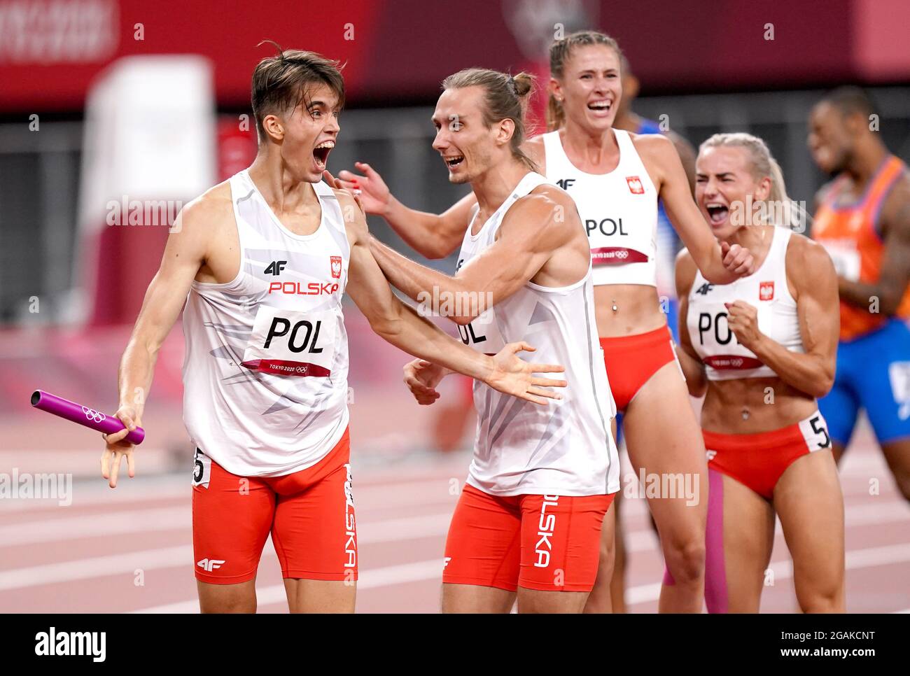 Poland's Kajetan Duszynski celebrates with teammates Karol Zalewski