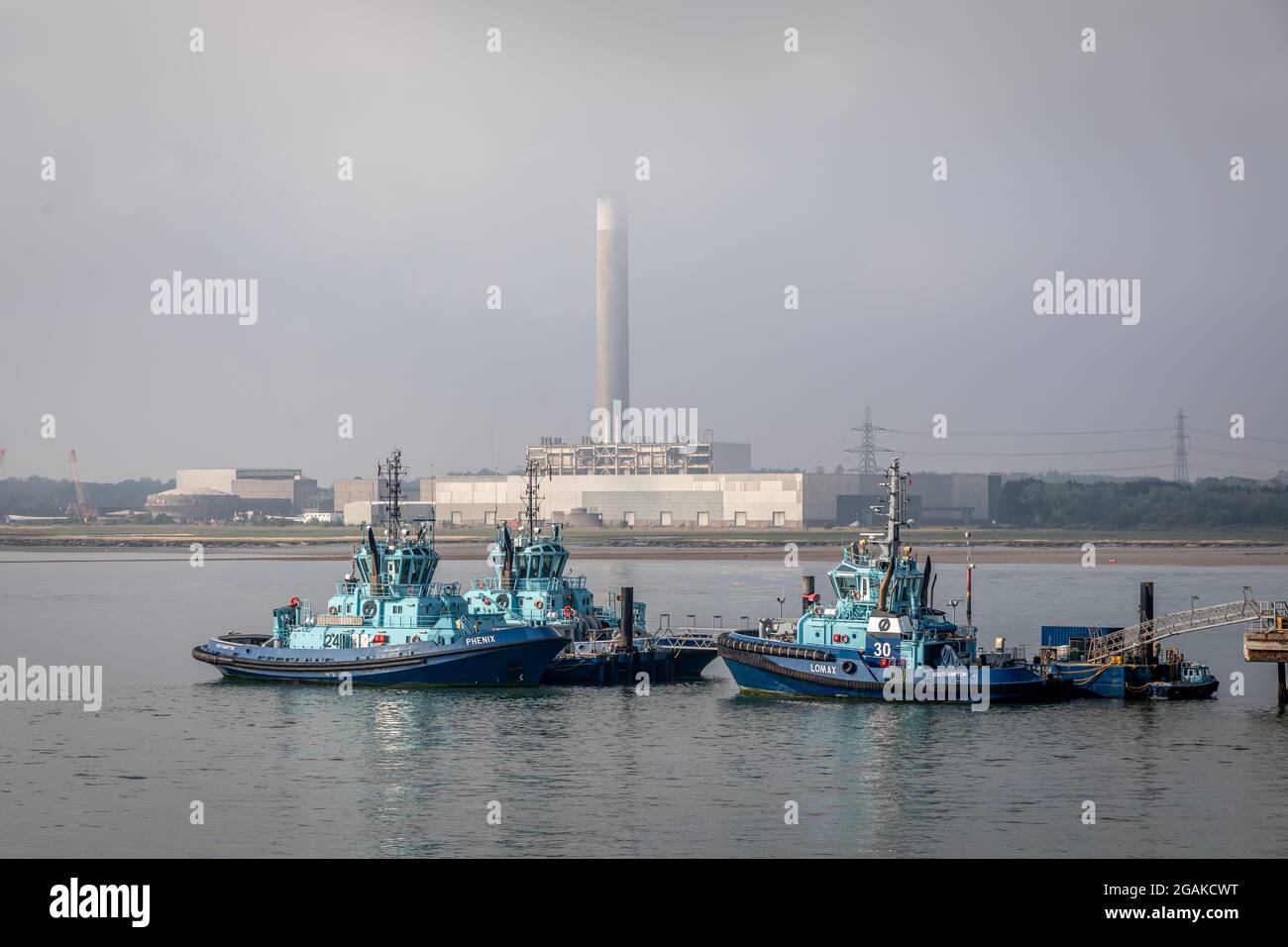 Tugs Phenix, Lomax, Apex at Fawley Oil Refinery Jetty, Hampshire, England, UK Stock Photo