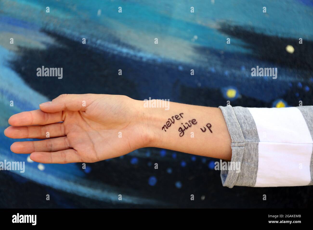 Female hand with tattoo on wall background Stock Photo - Alamy