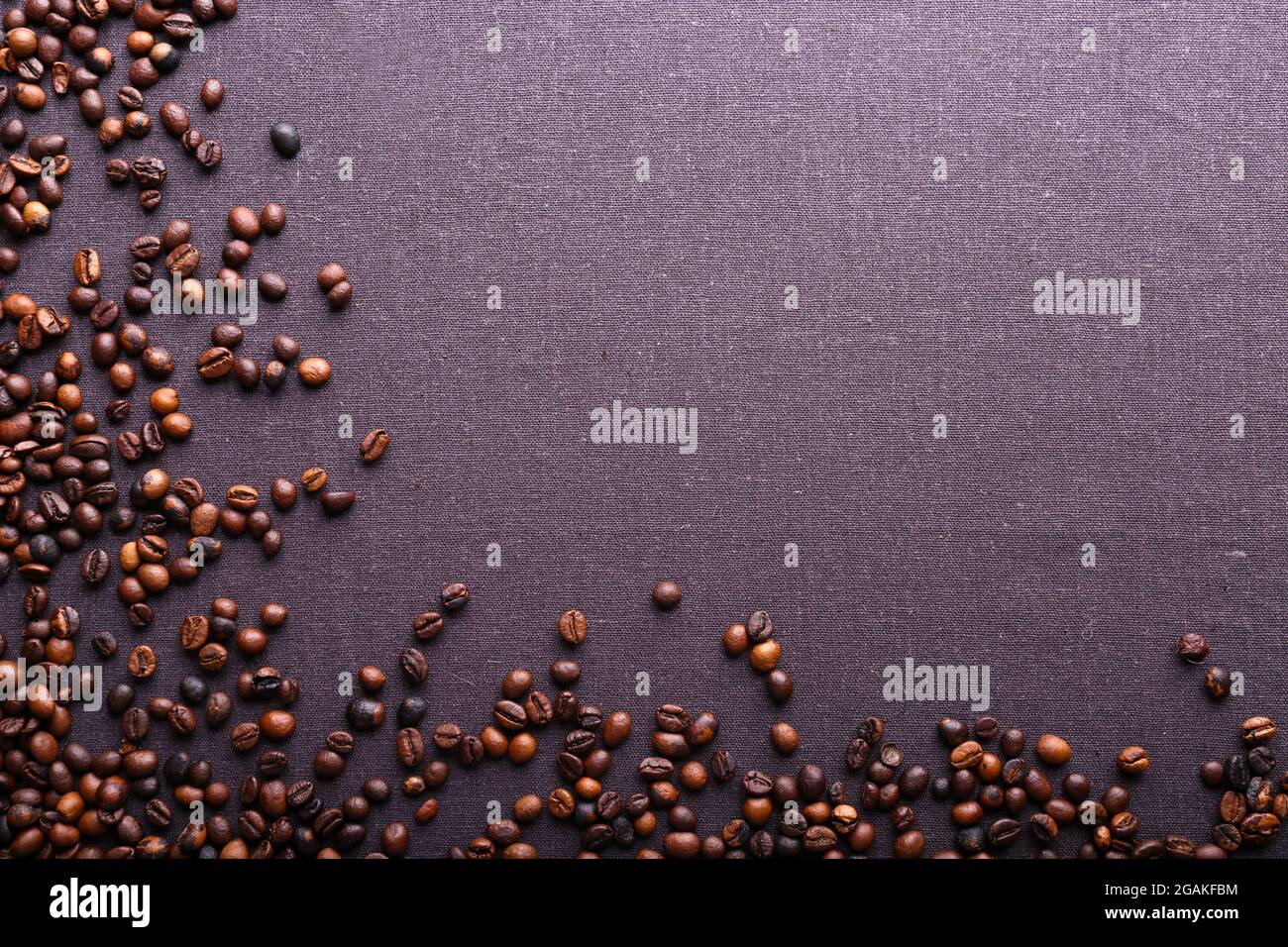 Roasted coffee beans on grey textile background Stock Photo - Alamy