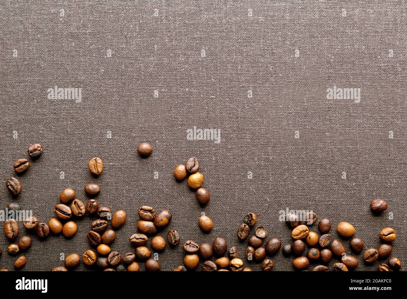 Roasted coffee beans on grey textile background Stock Photo - Alamy