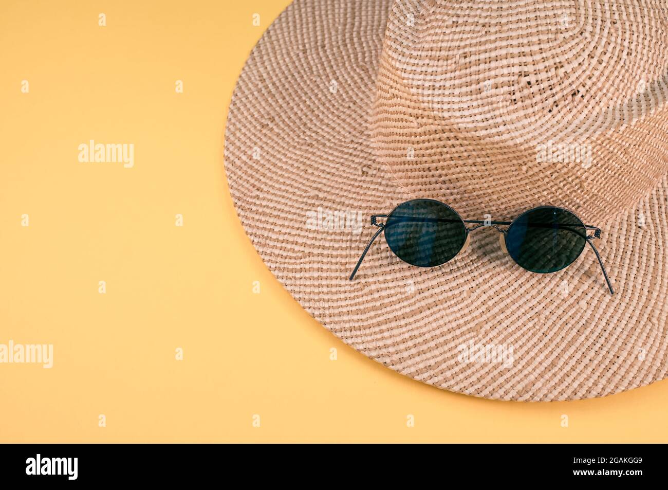 Top view of a straw hat and sunglasses on a yellow surface Stock Photo ...