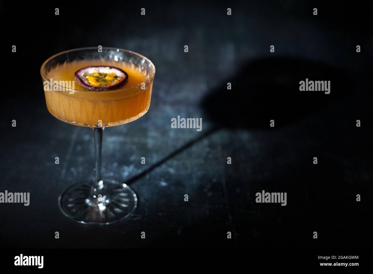 Passion fruit martini on dark background Stock Photo
