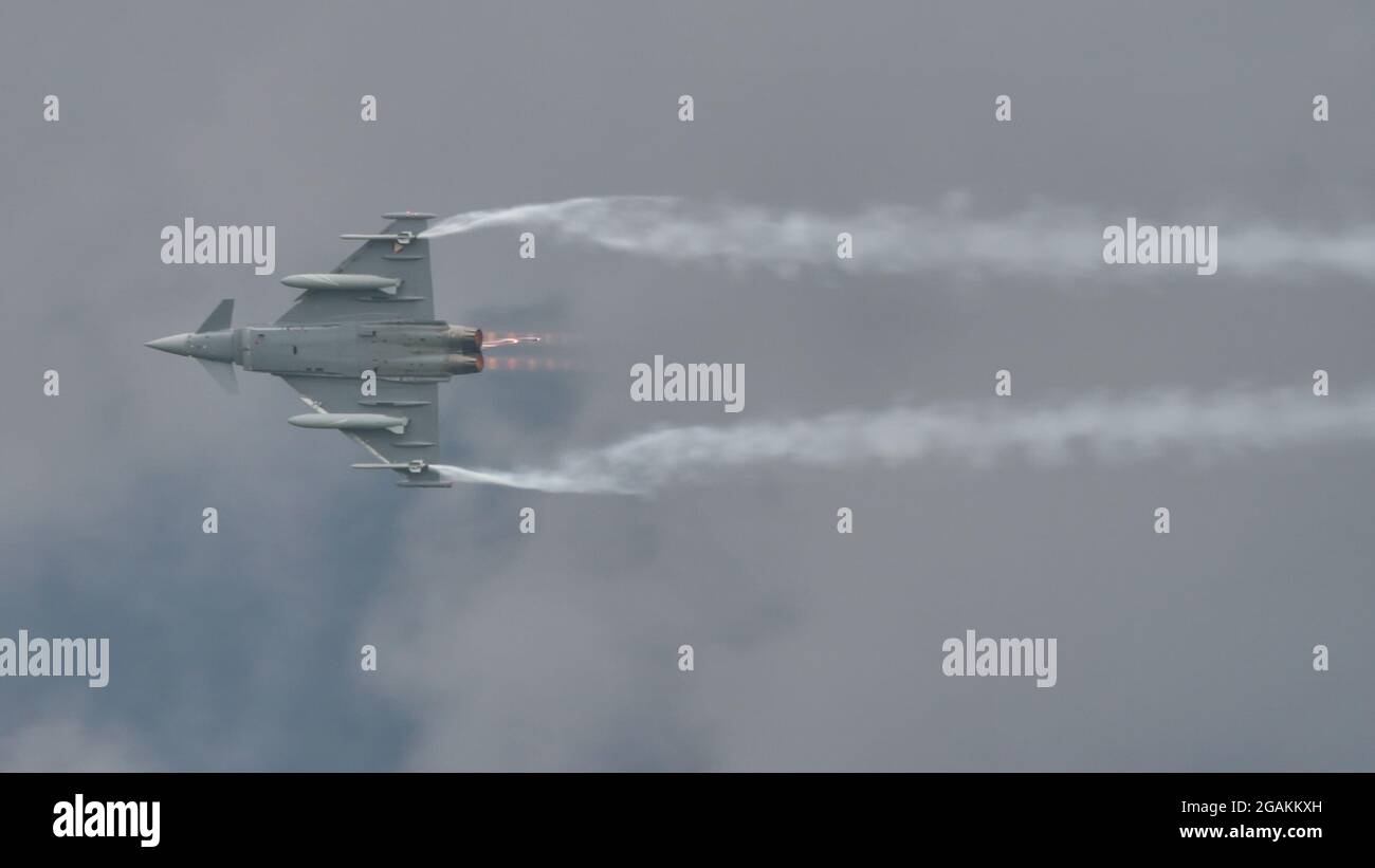 Zeltweg, Austria SEPTEMBER, 6, 2019 Military fighter jet flies in a bad weather, cloudy and raining grey sky. Eurofighter Typhoon of Austrian air Force Stock Photo