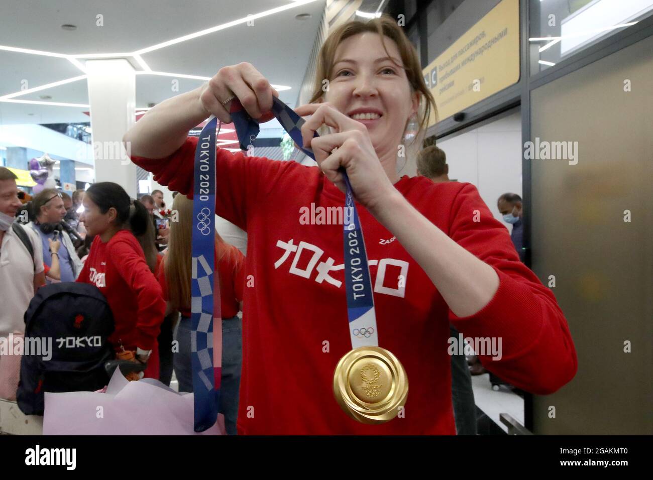 Moscow Region, Russia. 31st July, 2021. Olympic foil team champion/foil  individual bronze medallist Larisa Korobeinikova shows her medals as she  arrives at the Sheremetyevo International Airport from Tokyo after  participating in the